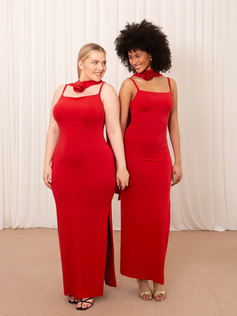 Two models showing what the same red famous AYM dresses would look like on different sizes.