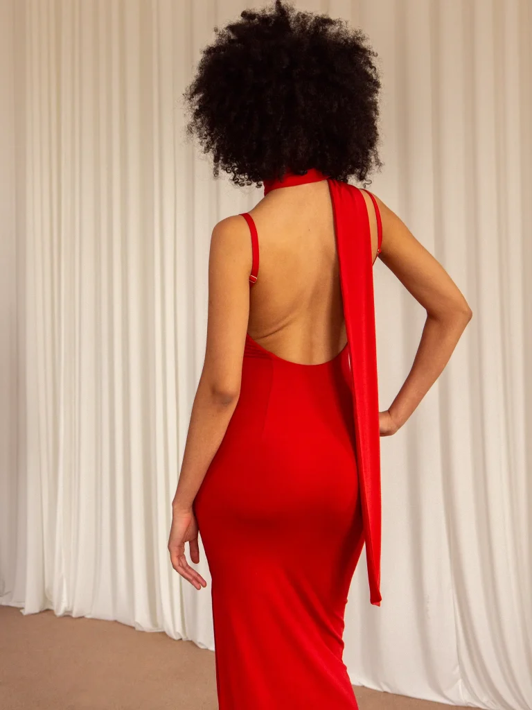 A model showing a smaller size of the red dress that we just saw from AYM dresses.