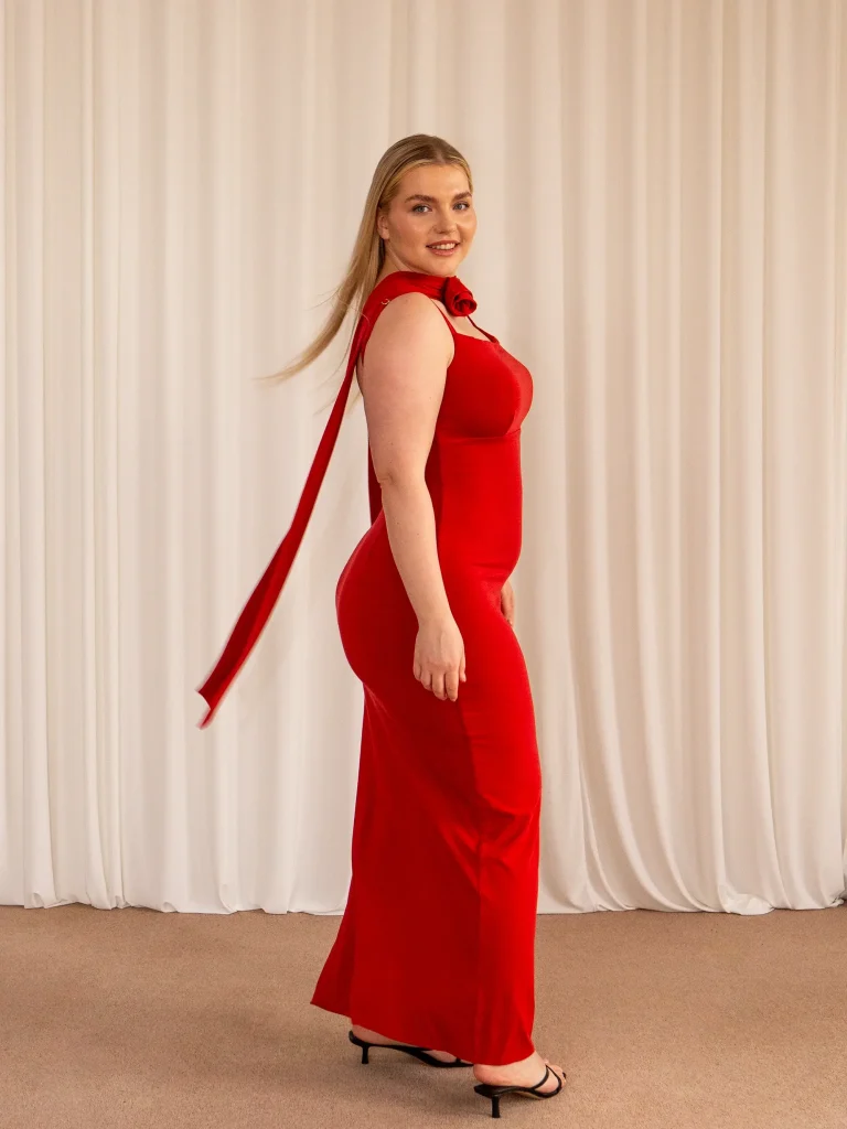 a model wearing one of the more popular AYM dresses. It is a red dress.